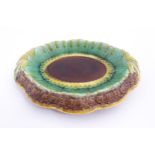 A Victorian majolica bread plate, the inner rim decorated with wheat sheaves, the outer edge bearing