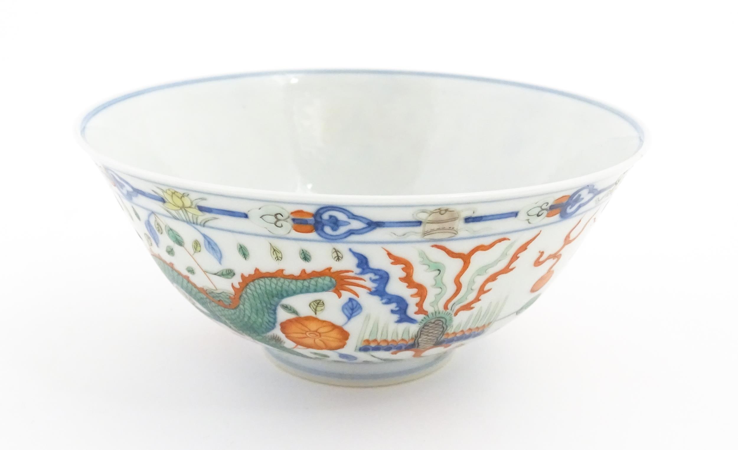 A Chinese bowl decorated with dragons, phoenix birds, flaming pearls and flowers. Character marks - Image 4 of 9