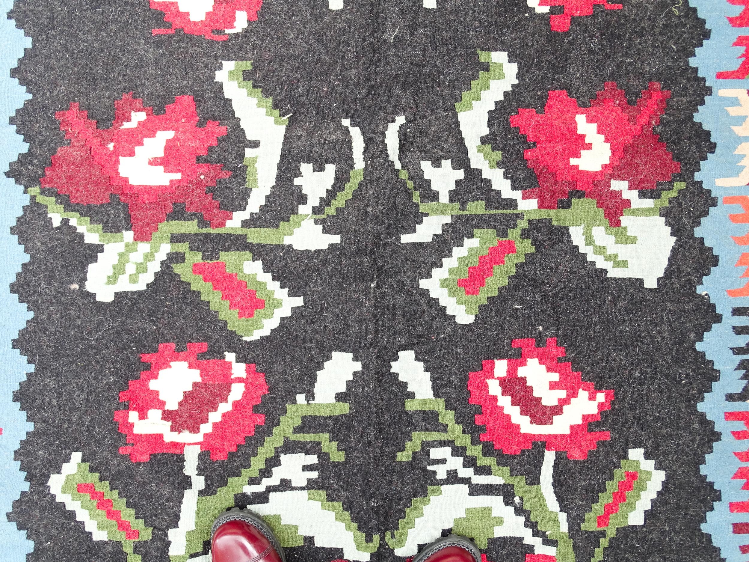 Carpet / Rug : A black ground rug with red floral decoration, with geometric motifs to borders. - Image 7 of 9