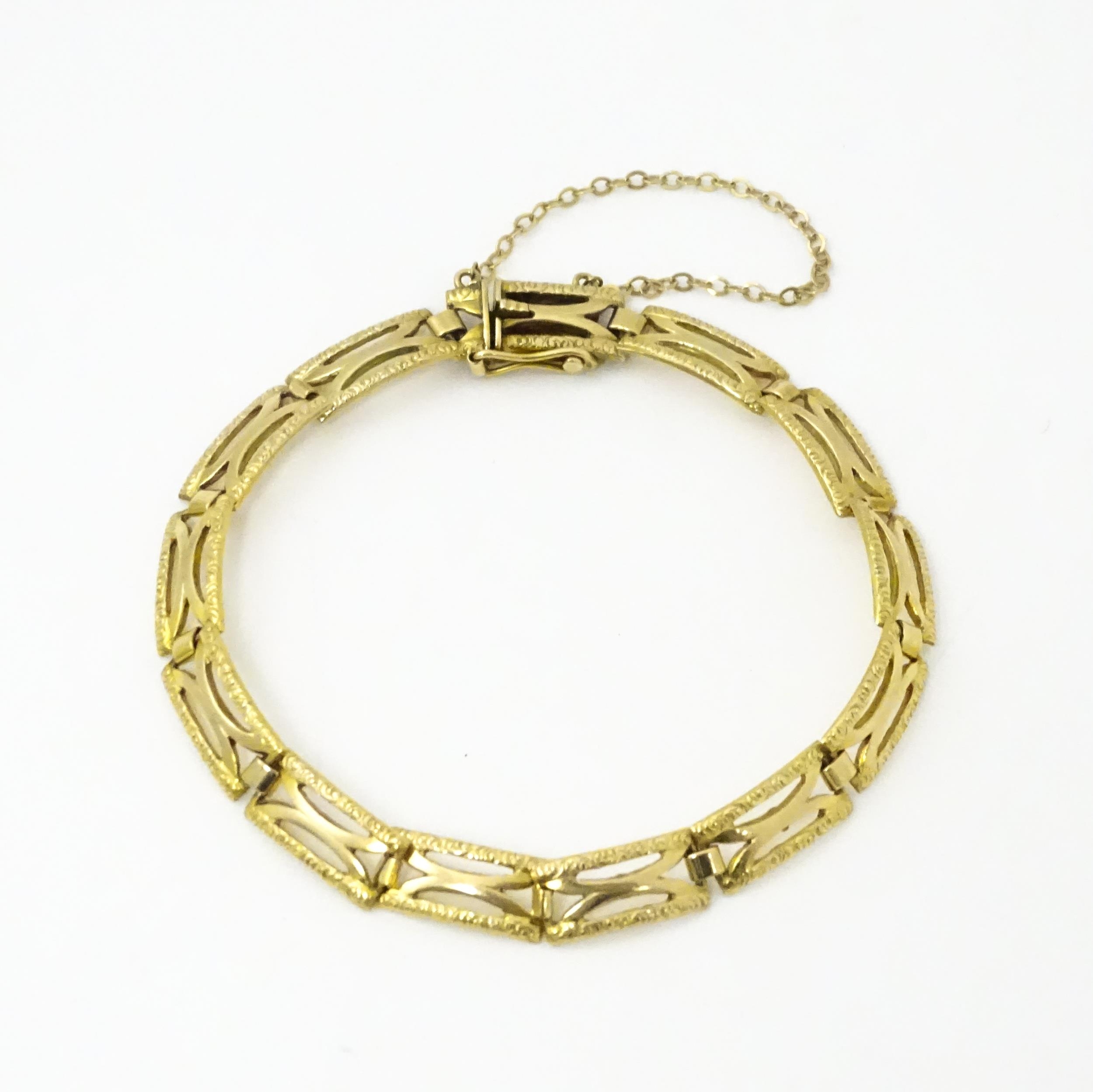 A 9ct gold bracelet with textured detail. Approx 7" long Please Note - we do not make reference to