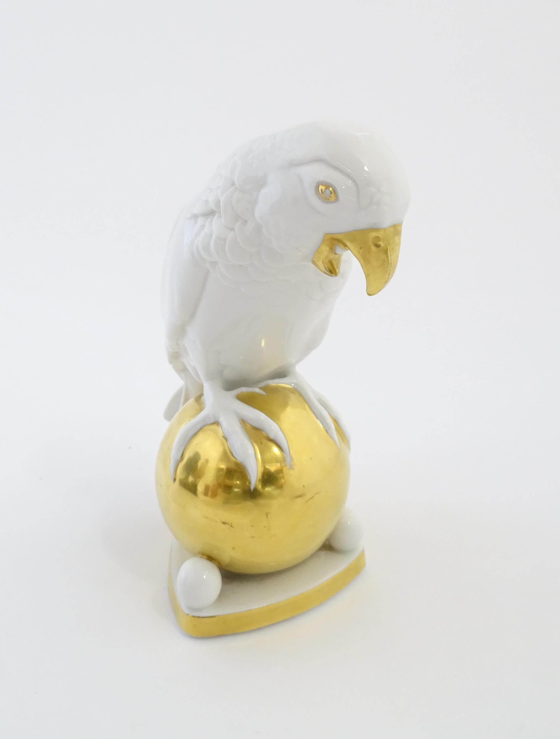 A Hutschenreuther model of a parrot perched upon a gilt ball. Marked under. Approx. 8 1/4" high - Image 3 of 8