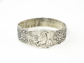 A Continental .830 silver napkin ring decorated with seated gnome and cat detail. Possibly