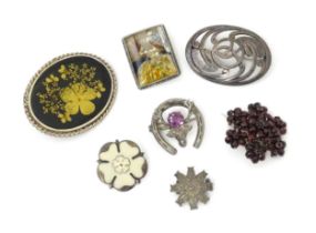 Seven assorted brooches to include some hallmarked silver examples, one formed as a white