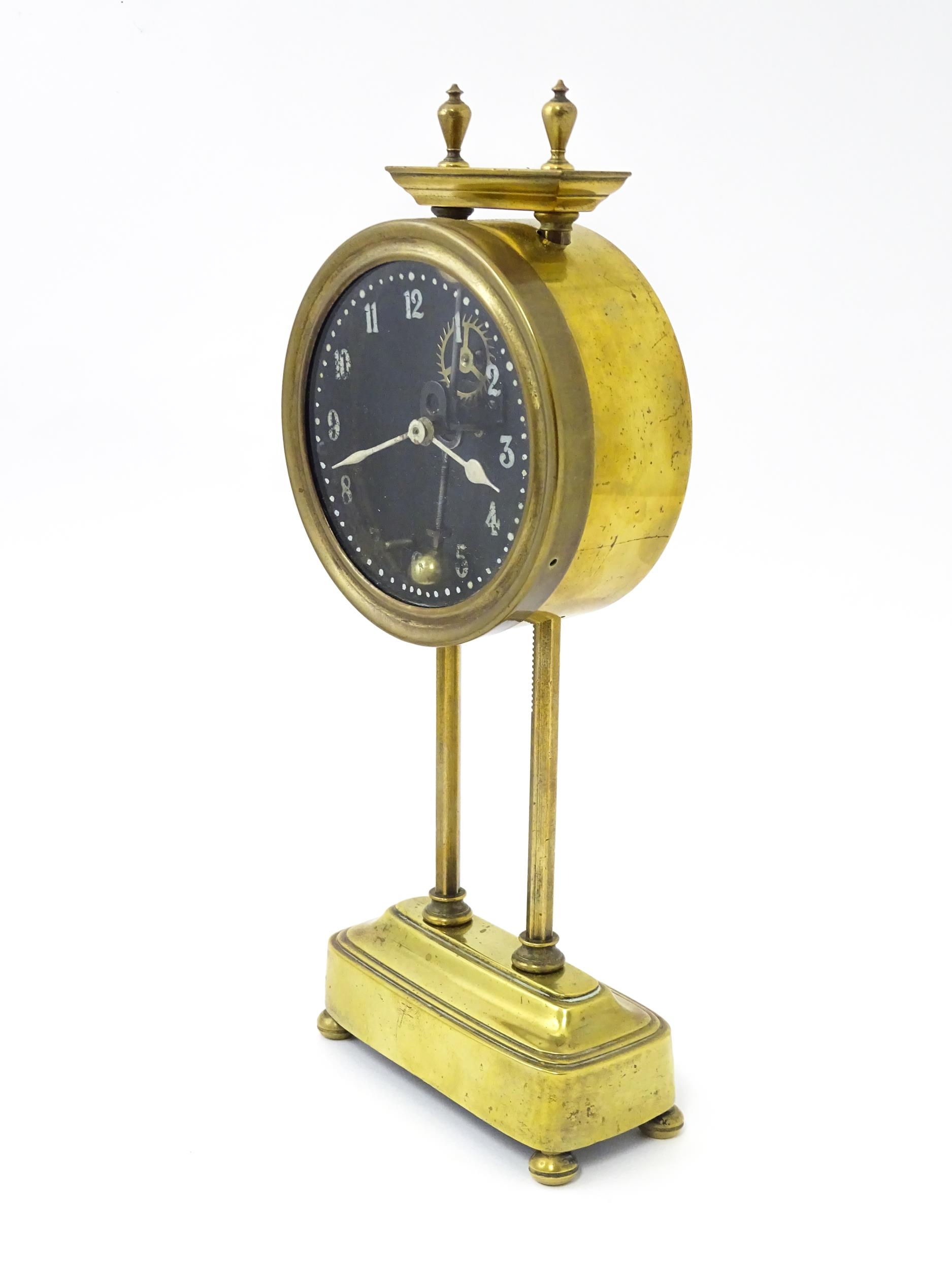 A brass cased Gravity clock with dial with Arabic numerals and having exposed escapement. Marked - Image 5 of 9