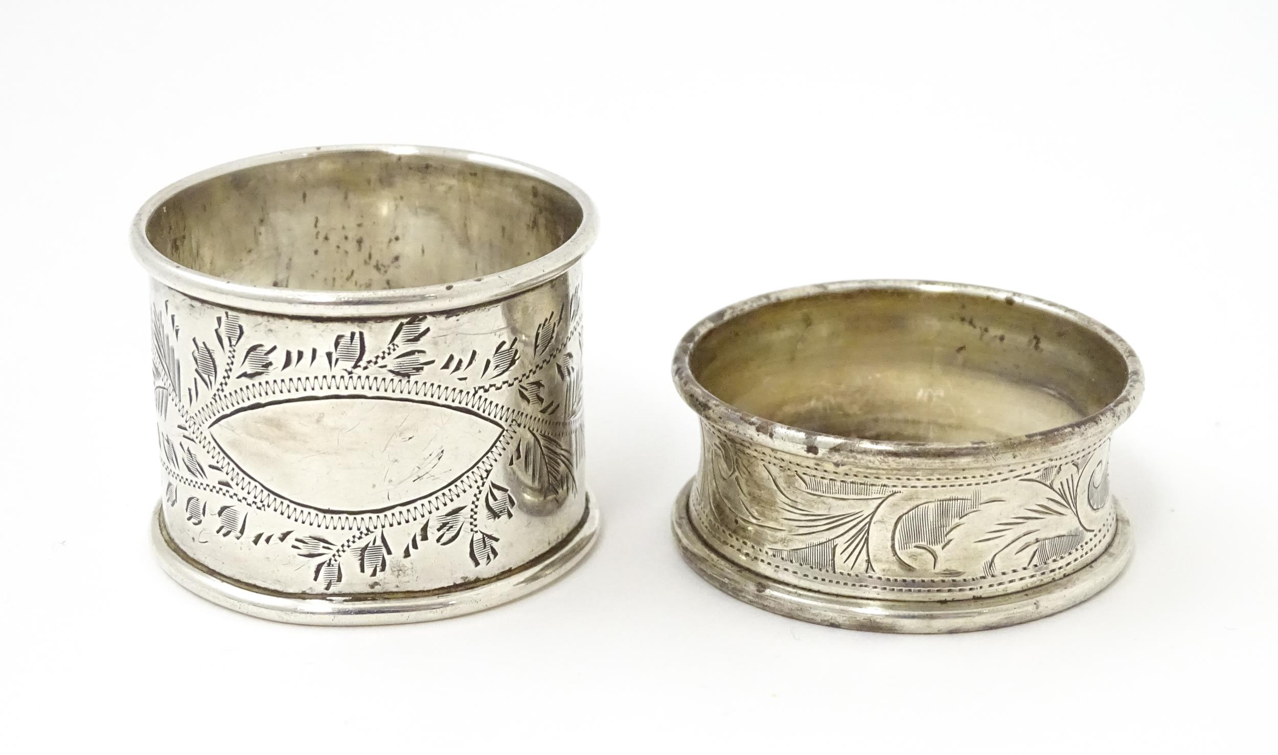 Two silver napkin rings with engraved foliate decoration, one hallmarked Birmingham 1928 maker