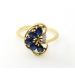 A 9ct gold ring set with 5 graduated blue spinel and two diamonds. Ring size approx. L 1/2 Please