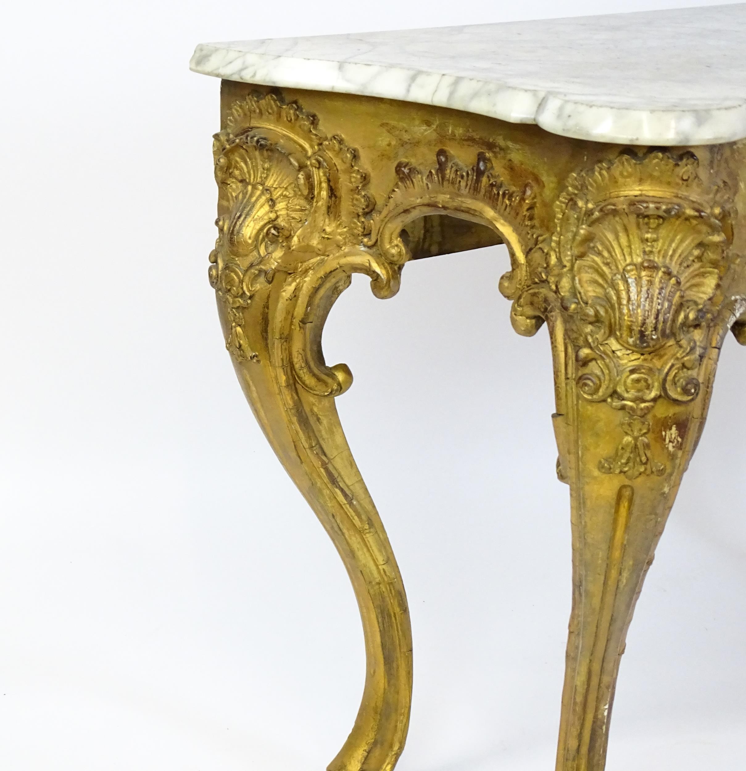 A 19thC marble topped table with a gesso and giltwood moulded base, decorated with shells, - Image 3 of 8