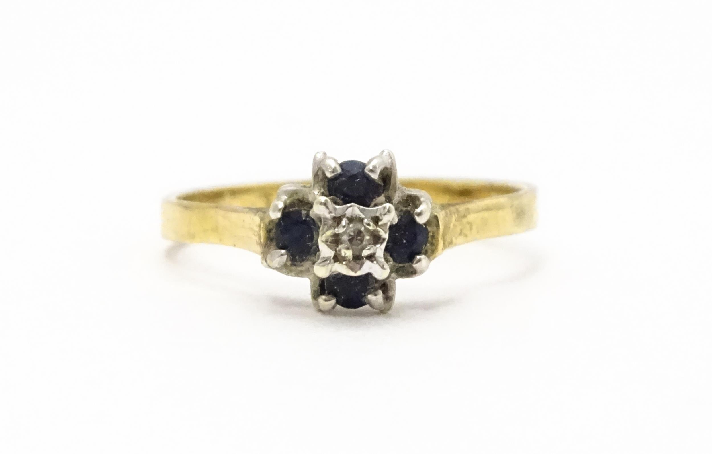 A 9ct gold ring set with diamonds and blue stones. Ring size approx. L Please Note - we do not
