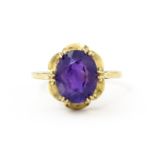 A 9ct gold dress ring set with amethyst. Ring size approx. M 1/2 Please Note - we do not make