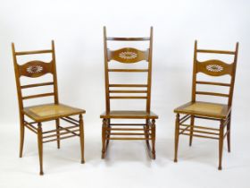 A group of three early 20thC Arts and Crafts style chairs comprising a rocking chair and two side