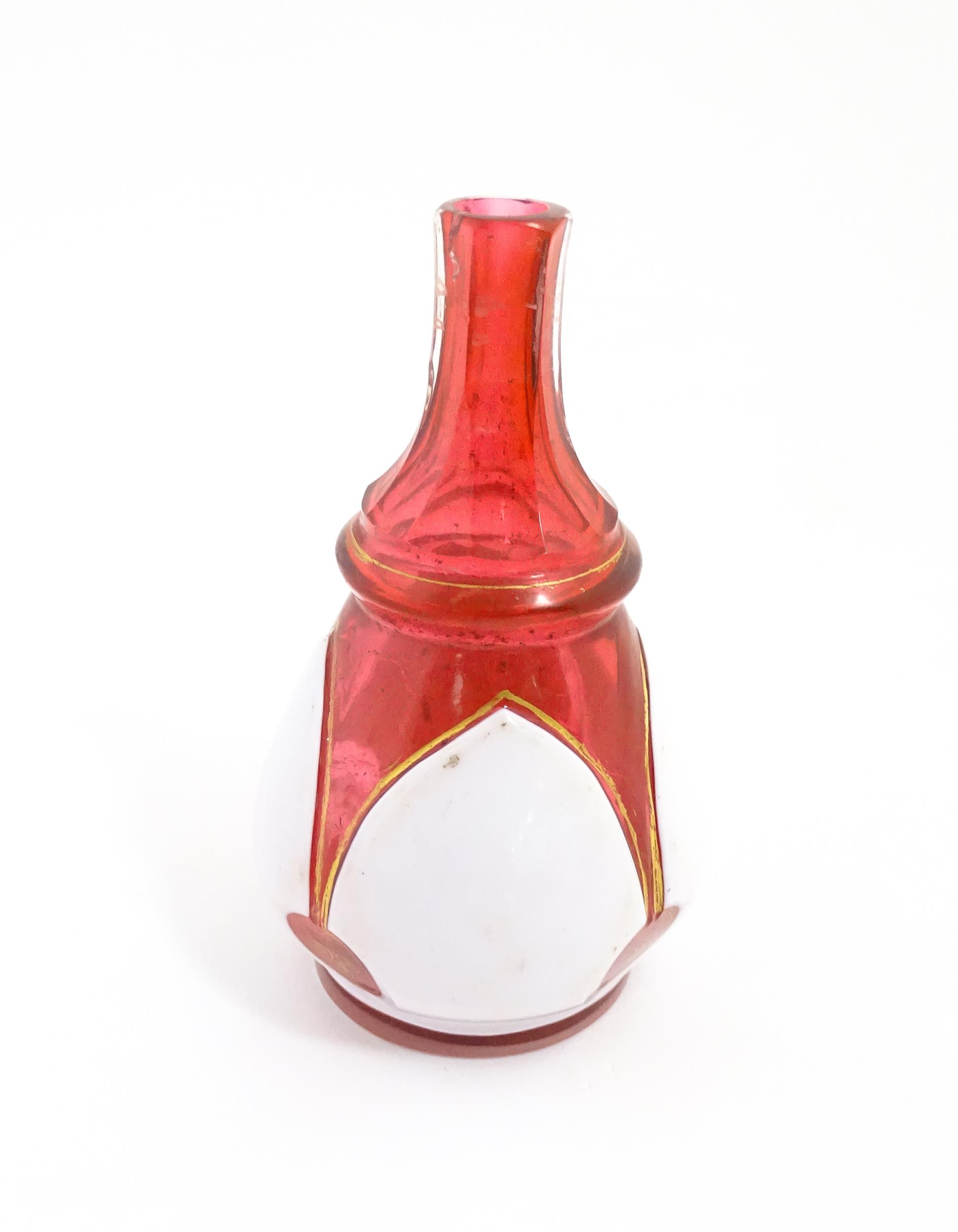 A small Bohemian style red and white glass bottle vase with gilt highlights. Approx. 3 3/4" high - Image 3 of 6