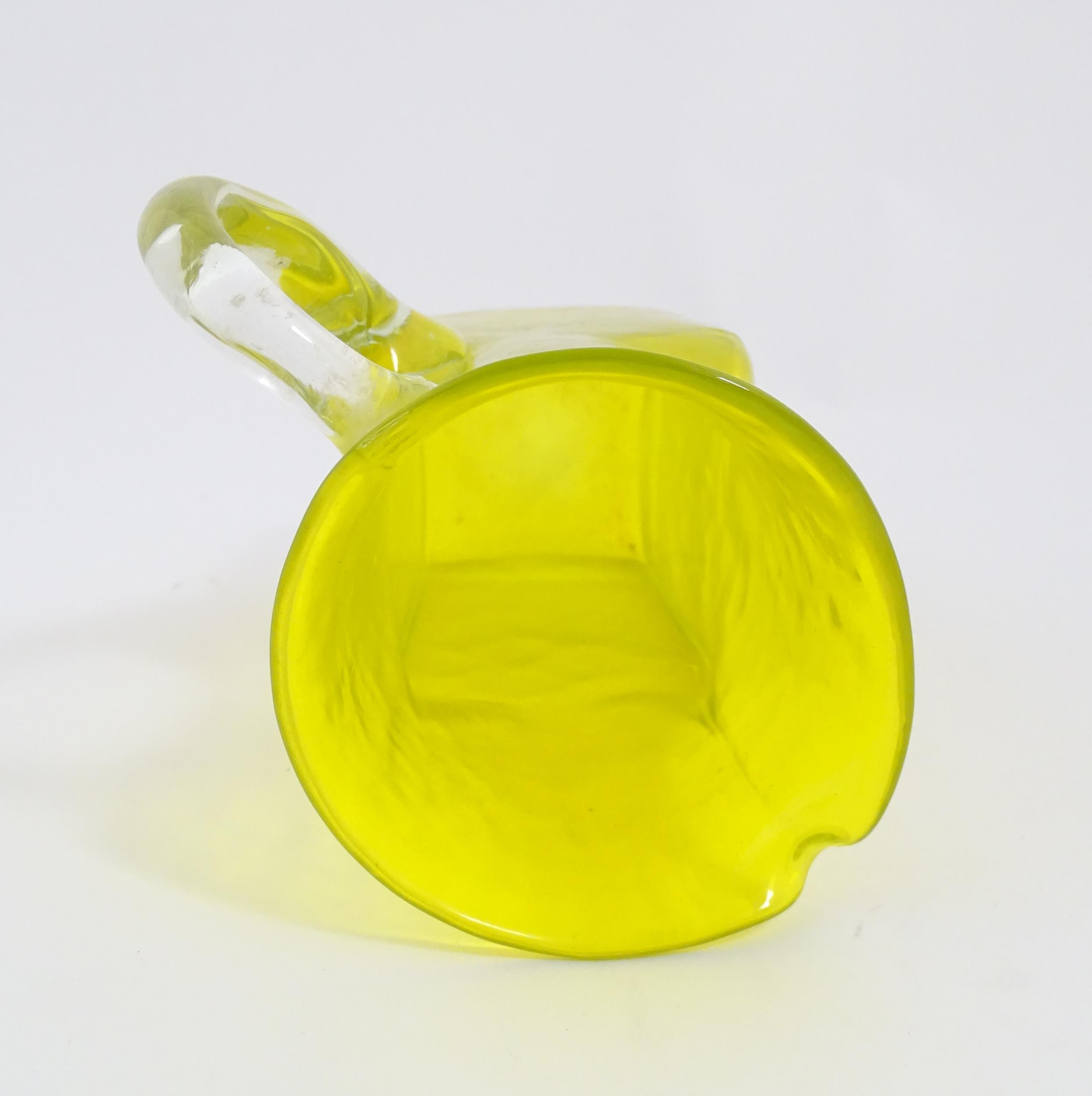 A 20thC yellow glass jug with squared base and clear glass handle. Approx. 8 1/2" high Please Note - - Image 2 of 11