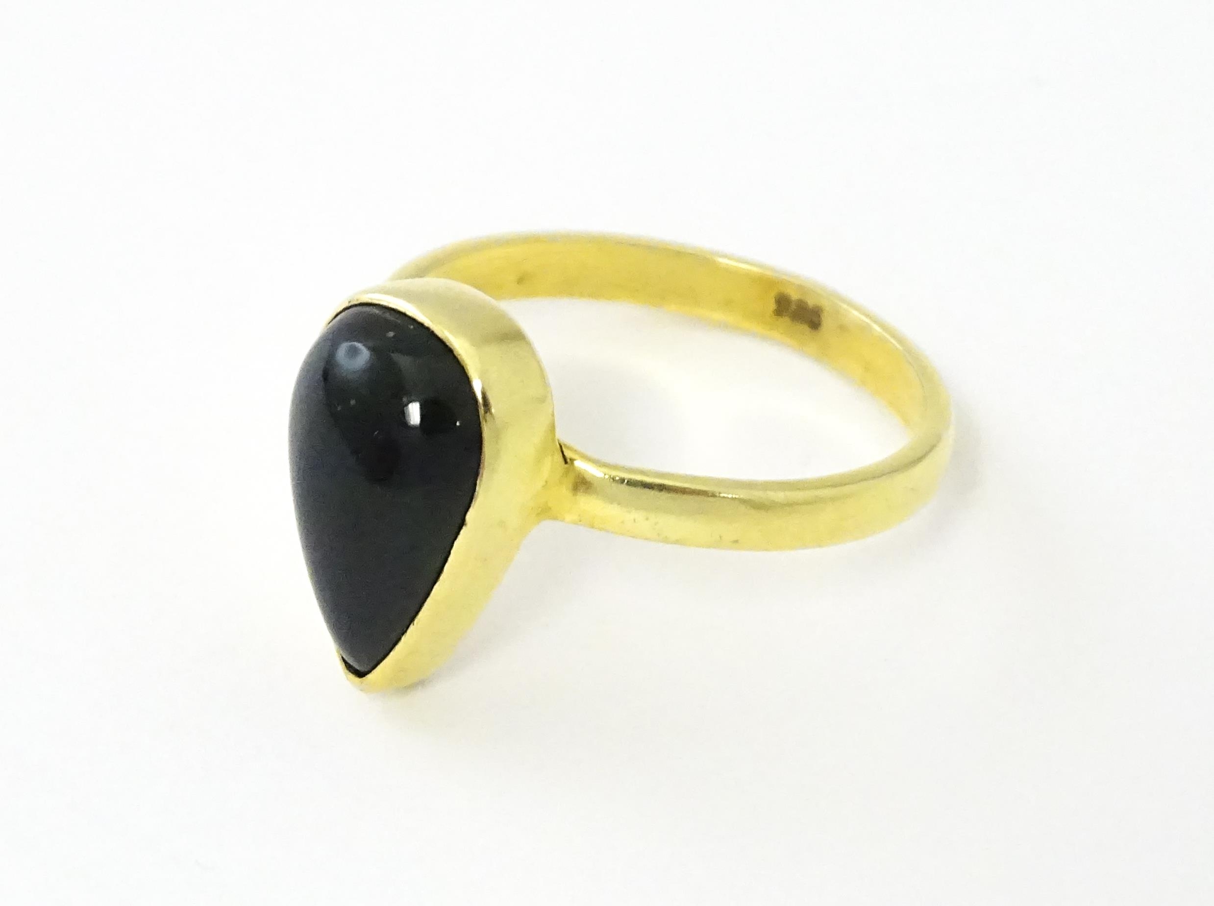 A silver gilt ring set with black opal style cabochon. Ring size approx. O. Please Note - we do - Image 2 of 6