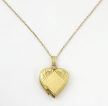A 9ct gold pendant locked of heart shape, together with a 9ct gold chain. The chain approx 16" long,