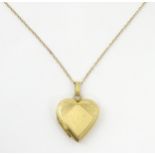 A 9ct gold pendant locked of heart shape, together with a 9ct gold chain. The chain approx 16" long,