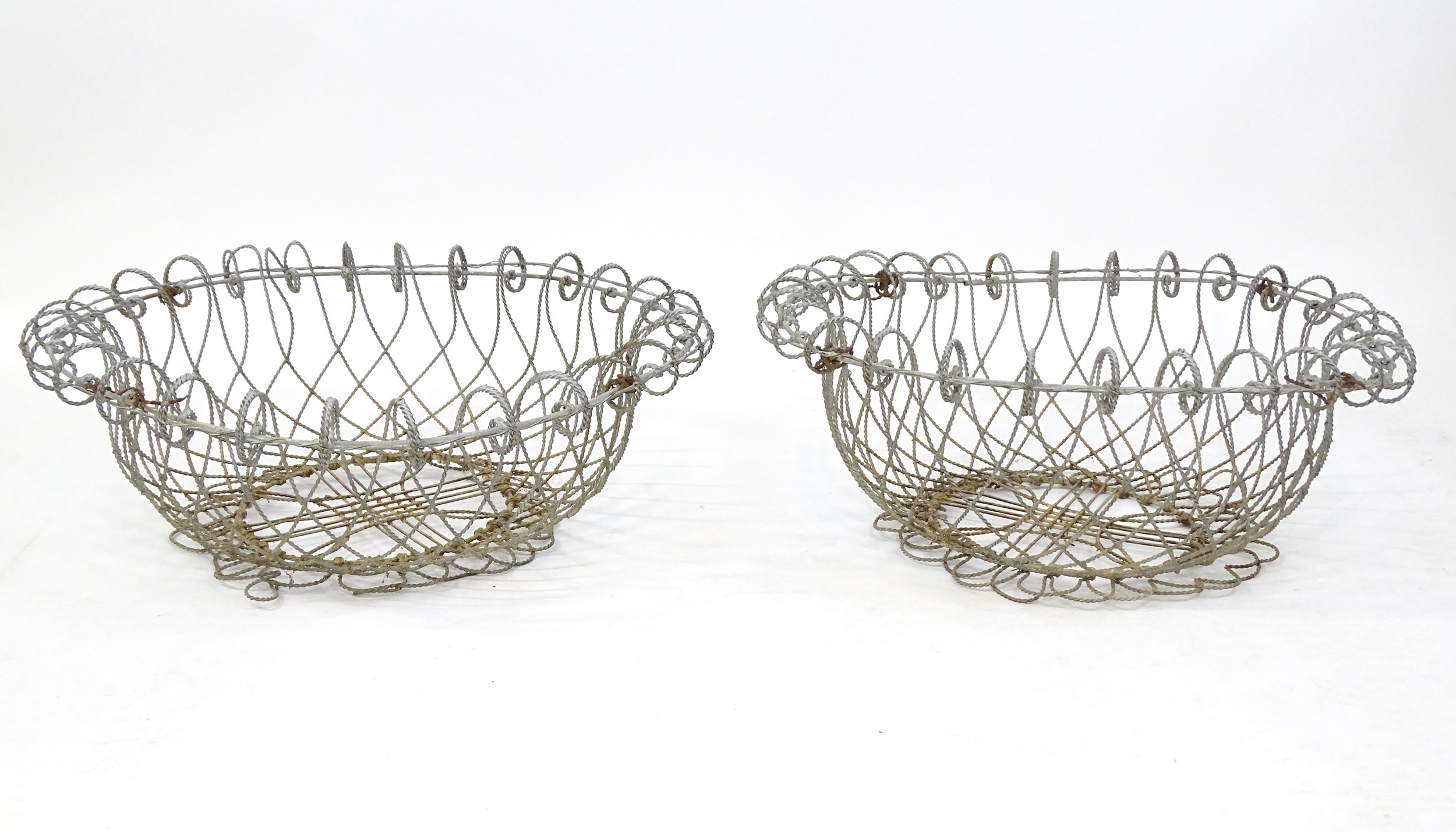 A pair of 19thC wirework planters / baskets with scrolling detail. Each approx. 24" in diameter x 8"