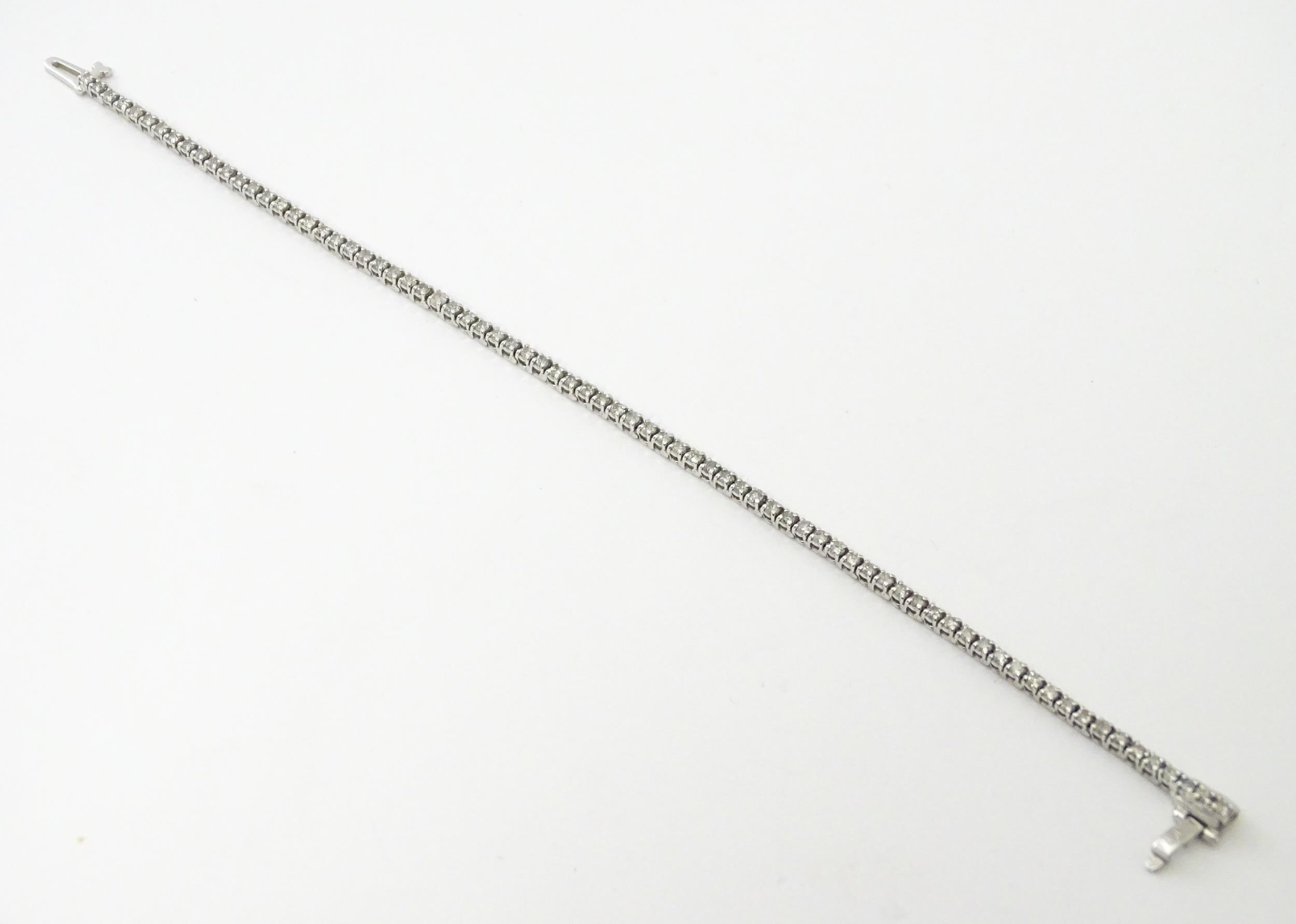 A 14ct white gold tennis bracelet set with diamonds. Approx 7 1/2" long Please Note - we do not make - Image 6 of 10