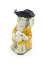 A 19thC Staffordshire pottery character Toby jug decorated in Pratt colours. Approx. 9 1/4" high