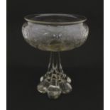 A glass centrepiece bowl comport with engraved floral and foliate detail on a lobed pedestal foot.