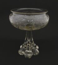 A glass centrepiece bowl comport with engraved floral and foliate detail on a lobed pedestal foot.