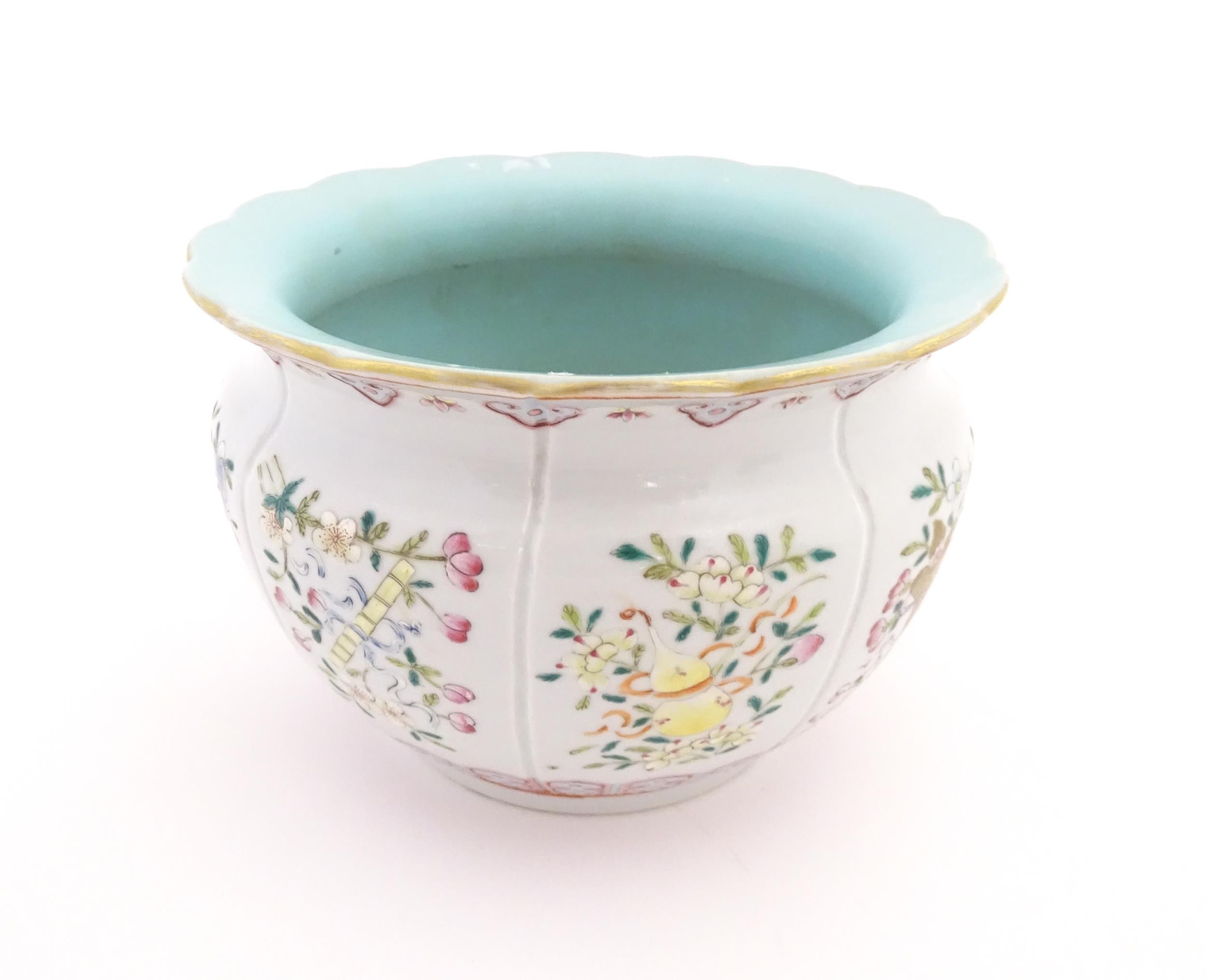 A Chinese famille rose bowl with scalloped edge decorated with flowers, foliage and scrolls. - Image 3 of 8