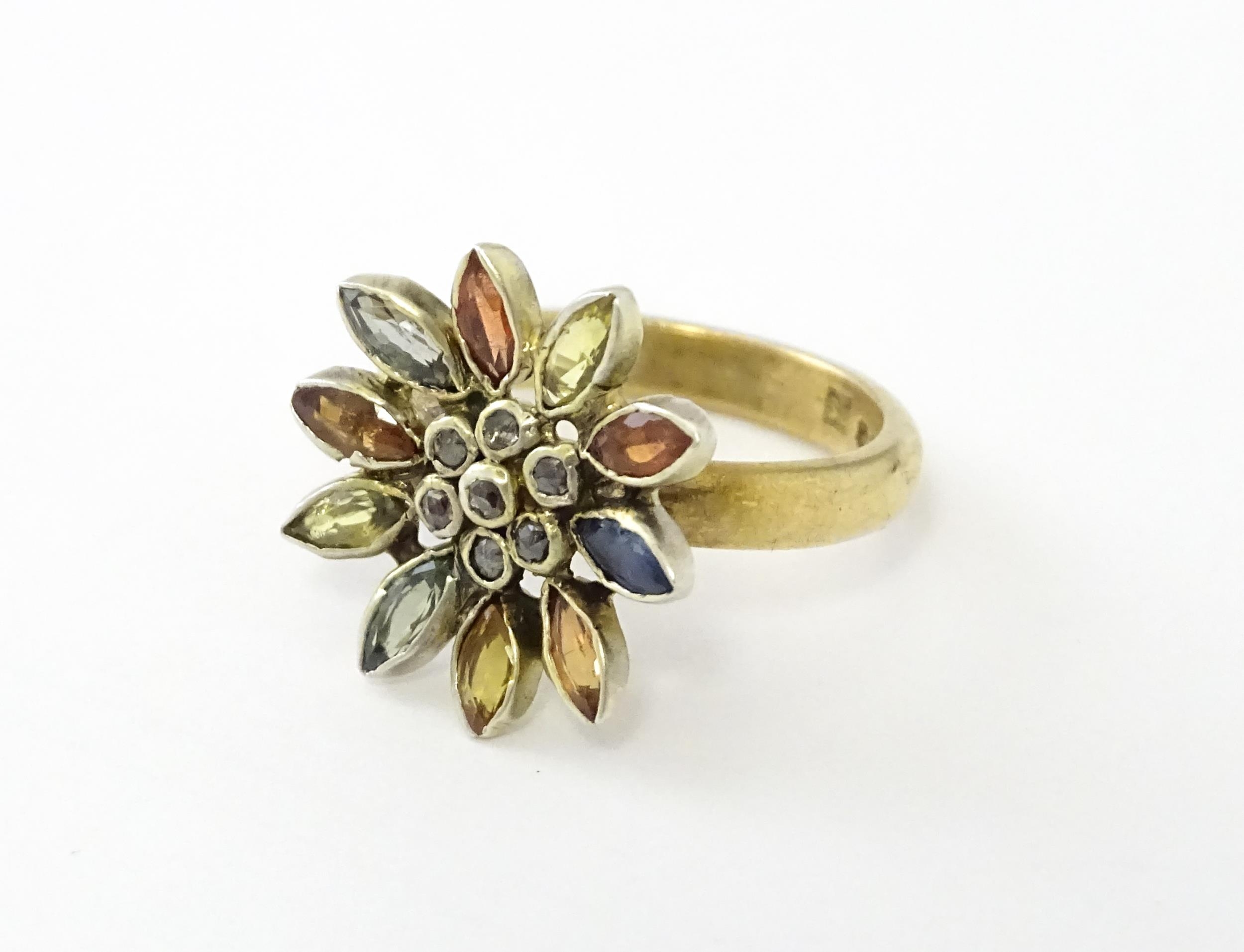 A 9ct gold ring set with central diamonds bordered by various coloured stones in a flower setting. - Image 2 of 6