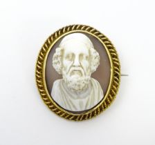 A 19thC shell carved cameo depicting the Greek poet Homer within a yellow metal mount and with