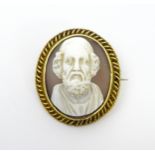 A 19thC shell carved cameo depicting the Greek poet Homer within a yellow metal mount and with