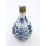 A Chinese blue and white bottle vase decorated with flowers and foliage, with a metal mount. Approx.