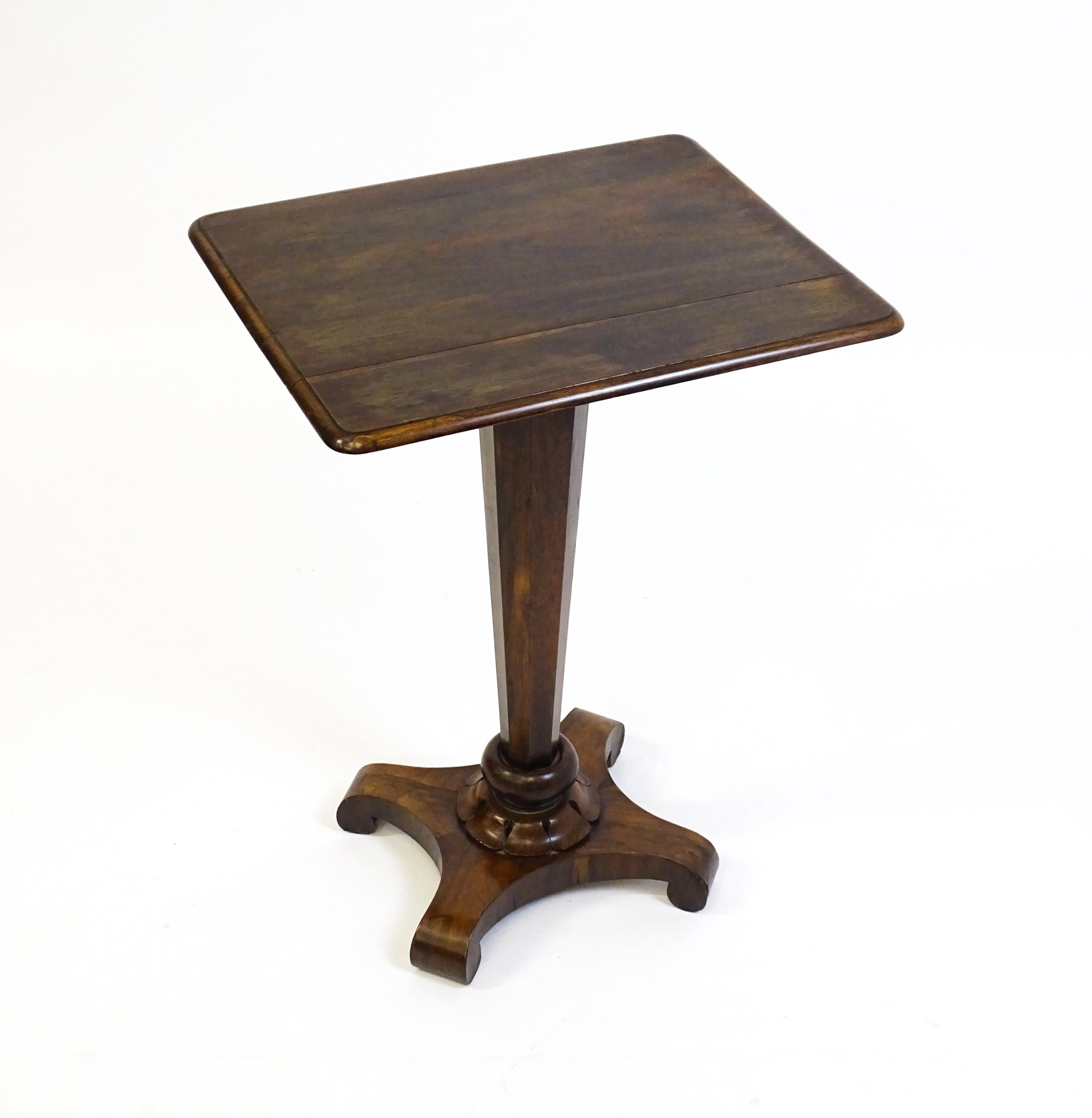 A 19thC rosewood occasional table with a canted pedestal above a carved plinth and quatre form