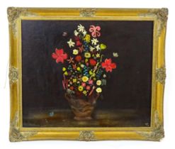 20th century, Oil on board, A naive study of flowers in a twin handled stoneware vase. Signed with