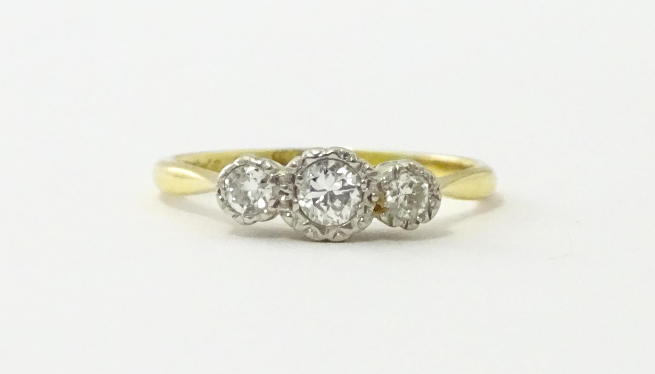 An 18ct gold ring with three platinum set diamonds. Ring size approx. O Please Note - we do not make - Image 4 of 18