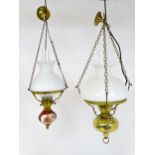 Two pendant oil lamps one with ceramic reservoir with floral detail. Largest approx. 11" wide (2)