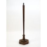 An Art Deco style oak standard lamp with a chamfered stem and a moulded hexagonal base. Approx.