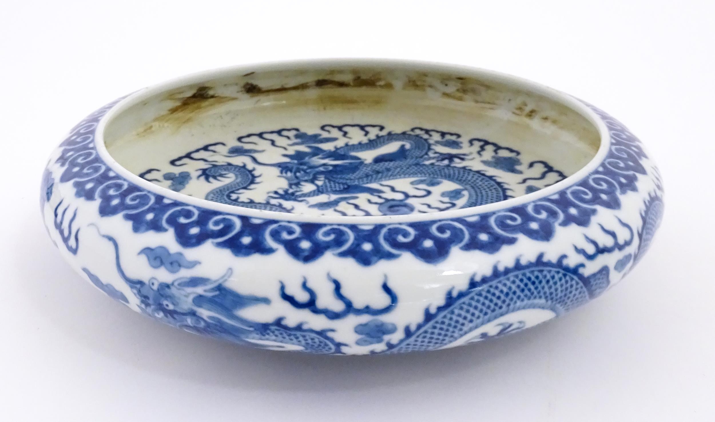 A Chinese blue and white dish decorated with dragons amidst clouds. Character marks under. Approx. - Image 3 of 8