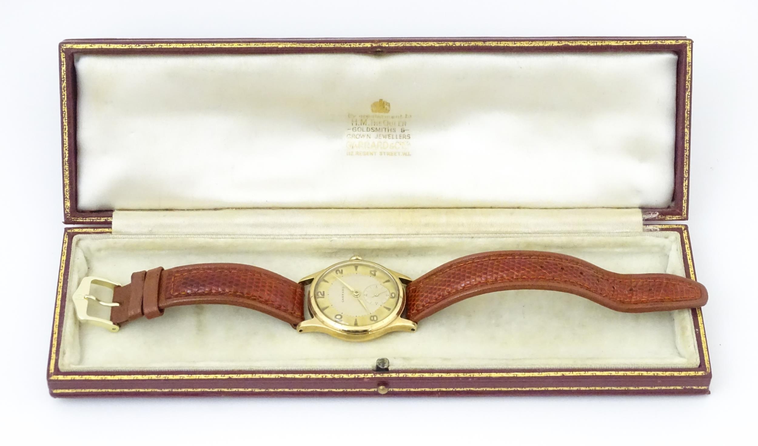 A gentlemans 9ct gold cased wristwatch the dial signed Garrard with Arabic numerals and subsidiary - Image 3 of 11