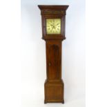 Dickerson, Framlingham : An oak cased 8-day longcase clock with brass face having Roman numerals and
