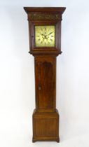Dickerson, Framlingham : An oak cased 8-day longcase clock with brass face having Roman numerals and