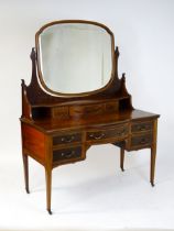 A late 19thC / early 20thC mahogany Maple & Co dressing table with a decoratively strung mirror
