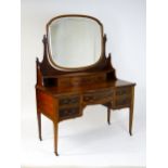 A late 19thC / early 20thC mahogany Maple & Co dressing table with a decoratively strung mirror