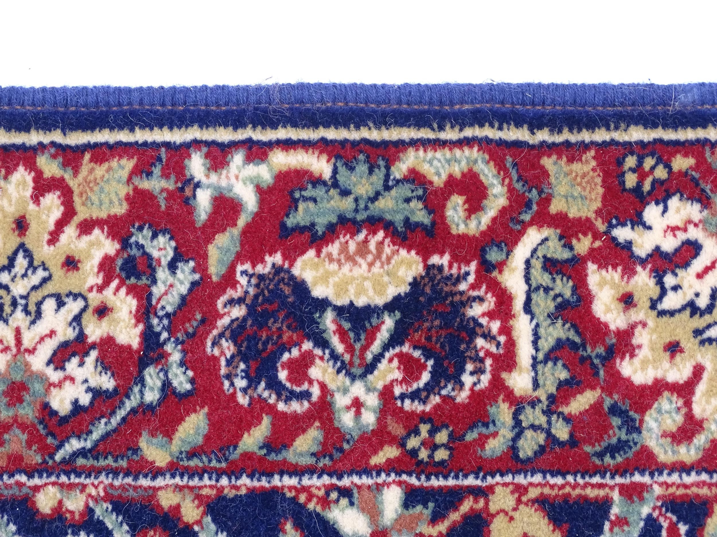 Carpet / Rug : A blue ground wool rug decorated with floral and foliate detail, further repeated - Image 4 of 9