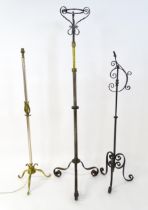 A 20thC standard lamp with triform base and foliate decoration. Together with two wrought iron style