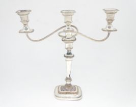 A large silver plate three branch table candelabra. Approx. 17 1/2" high Please Note - we do not