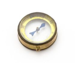 A pendant charm formed as a compass within a 9ct gold mount, hallmarked Chester 1913, maker Thomas