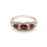 A 9ct white gold ring set with rubies and diamond. Ring size approx. M 1/2 Please Note - we do not