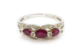 A 9ct white gold ring set with rubies and diamond. Ring size approx. M 1/2 Please Note - we do not