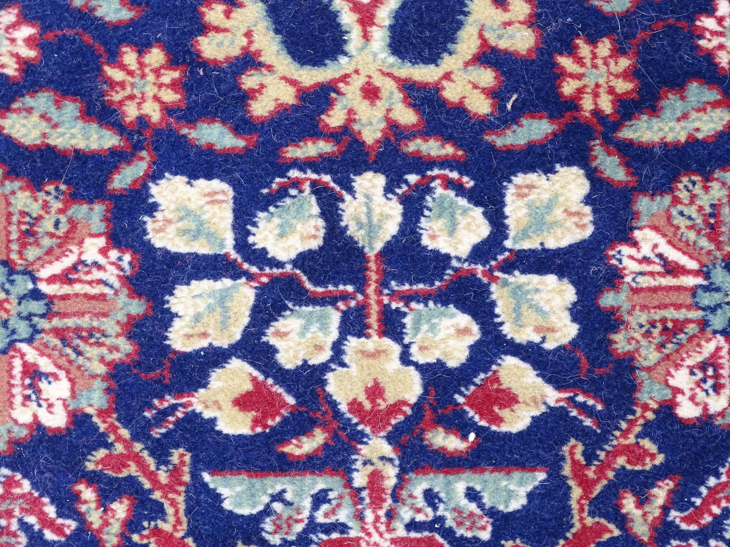 Carpet / Rug : A blue ground wool rug decorated with floral and foliate detail, further repeated - Image 6 of 9