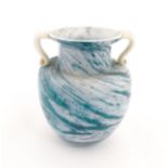 An Isle of Scilly blue glass vase with twin handles and white mottled swirl detail, signed D. Lang