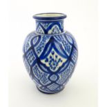 A Continental blue and white vase of baluster form with brushwork decoration. Approx. 9 1/4" high