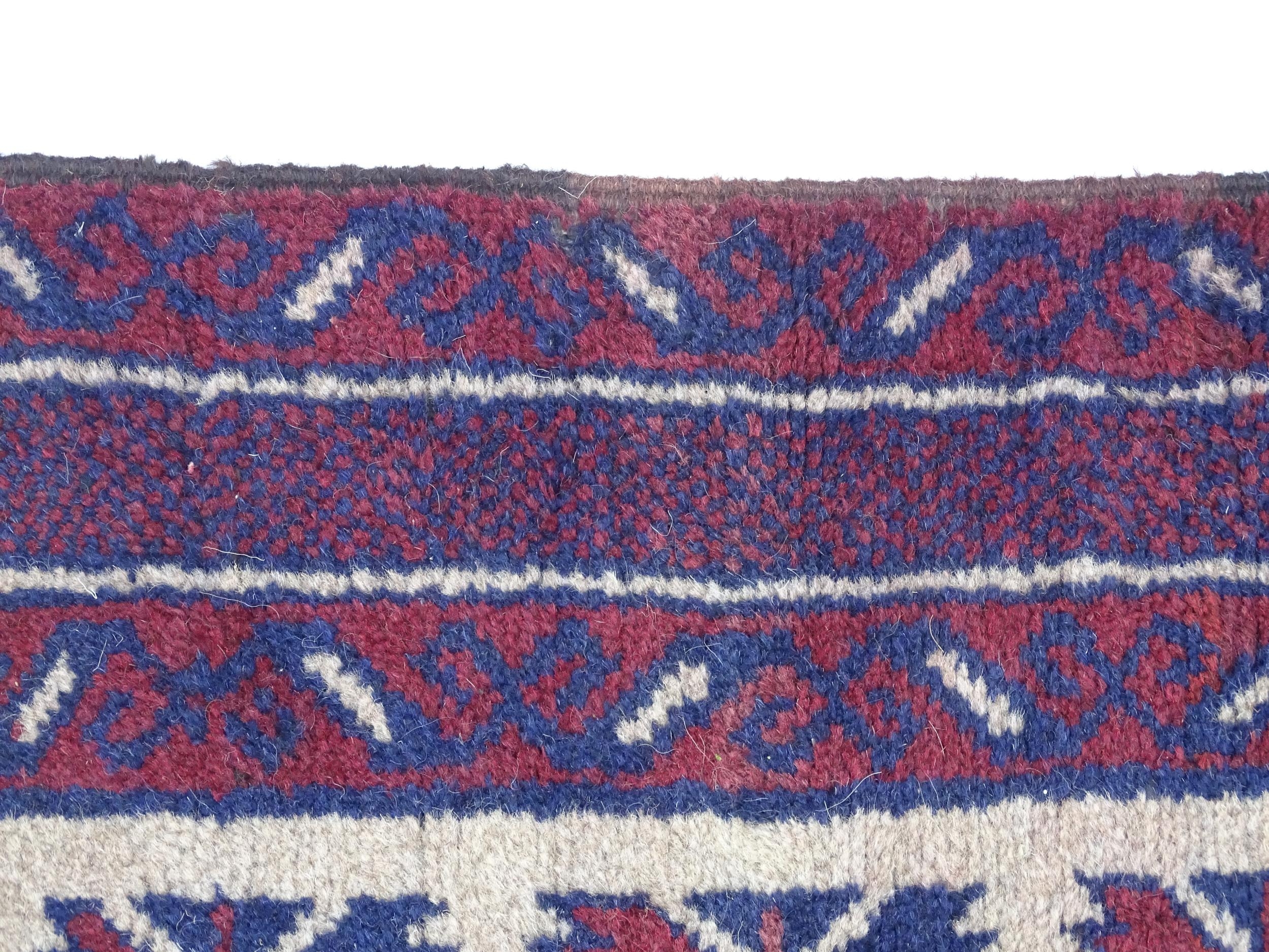 Carpet / Rug : A red, blue and cream ground rug with repeating geometric motifs. Approx. 55" x 29" - Image 6 of 7